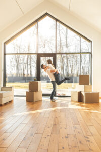 young couple moves to a new home. the family carries boxes of things after buying a home.