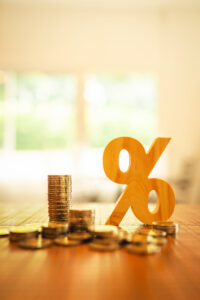 Percentage model with coins stack. Concepts of the banking system, rising interest rates, inflation, deflation, and savings.